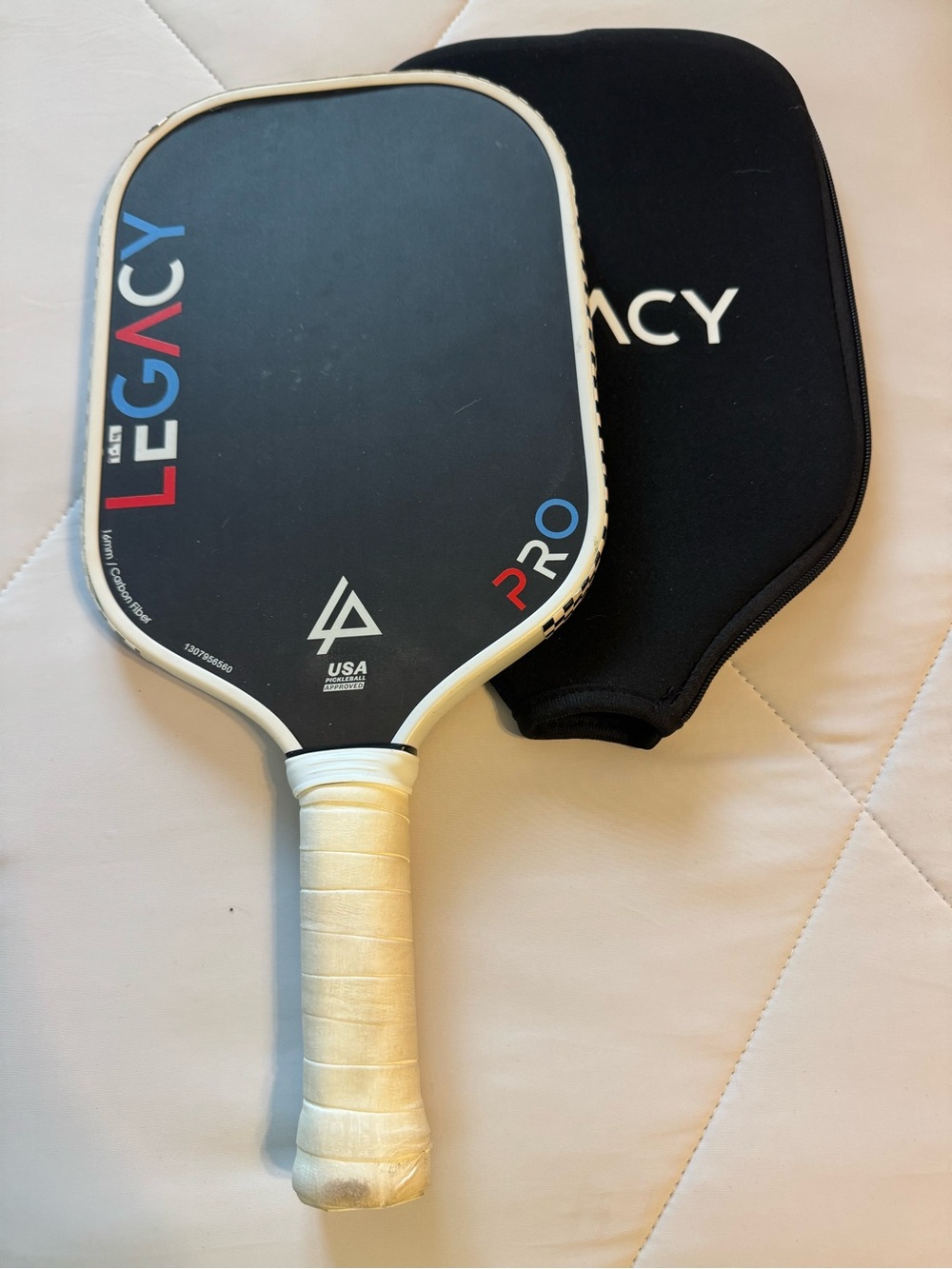 Legacy Pickleball Paddle in Black with White Grip and Red/Blue Accents